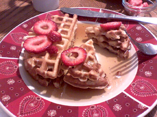 Waffles with strawberries and syrup